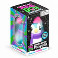 NeeDoh Polar Glow Penguin squishy with a pink hat and purple scarf in its box